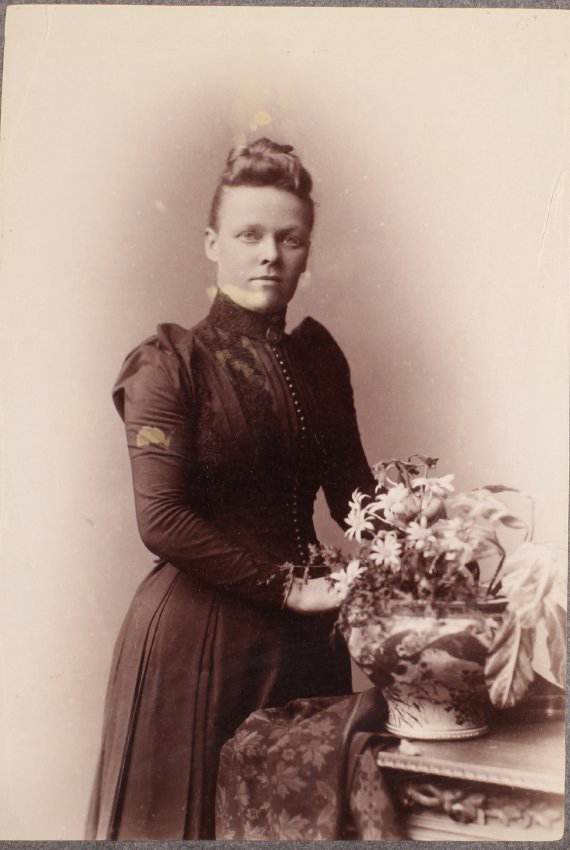 Unidentified woman with flowers and vase