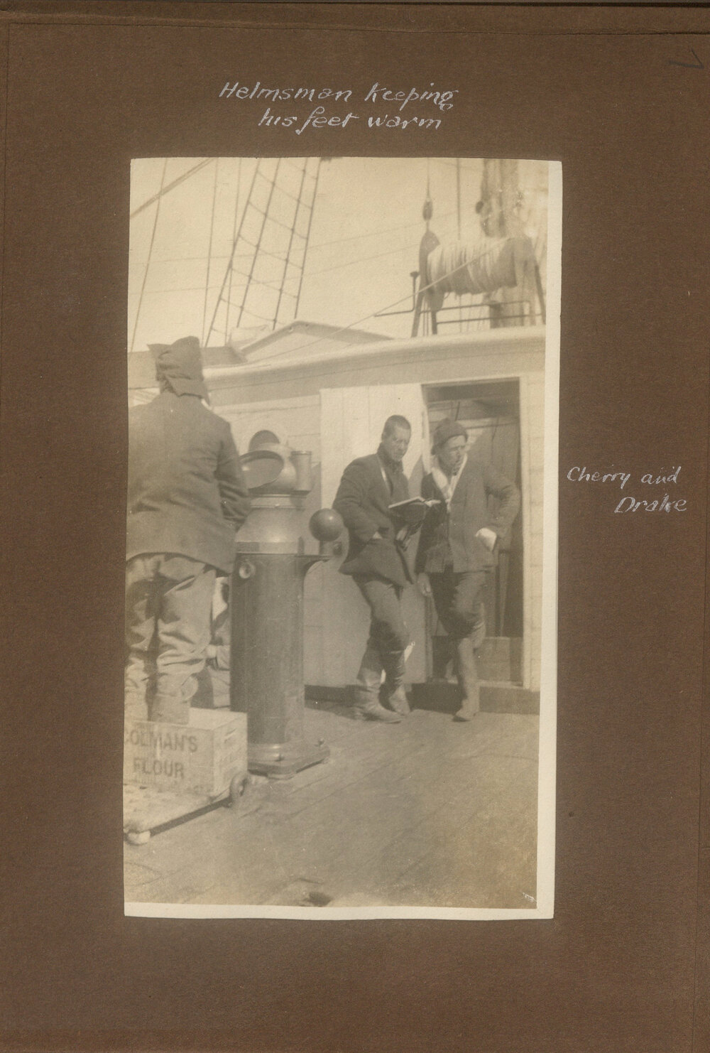 Helmsman keeping his feet warm on the Terra Nova, showing Cherry and Drake