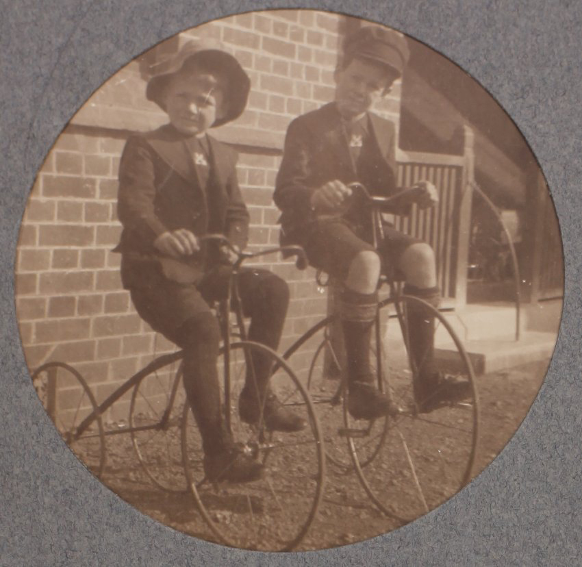 Two boys on tricycles