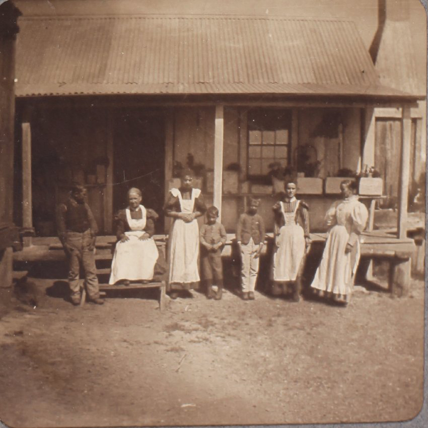 [Unidentified family and cottage]