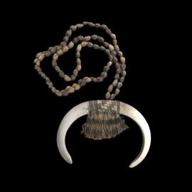 MA2012.7.1 Brown Painted seed necklace with semi-cicular bone