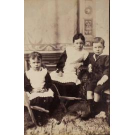 Three unidentified children seated