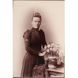 Unidentified woman with flowers and vase