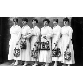 F.J. White's daughters and friends with their WWI badge collections