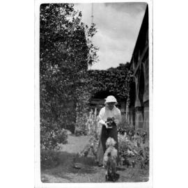 A woman photographing and a dog