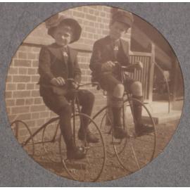 Two boys on tricycles