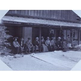 The tour party on a verandah