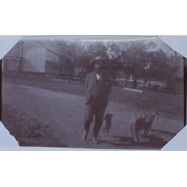 A man and three dogs
