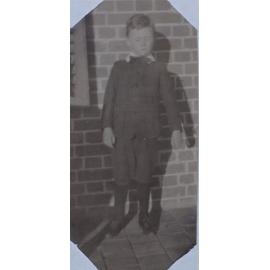 A boy on a homestead verandah, 1