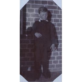A boy on a homestead verandah, 2