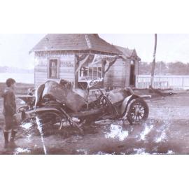Young man near a car and building