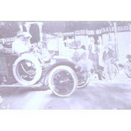 A couple in a car on a busy street