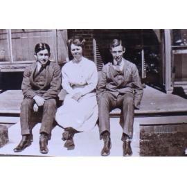 Unidentified woman and two young men