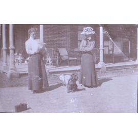 Two unidentified women with pet dogs