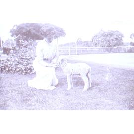 Unidentified woman with pet lamb