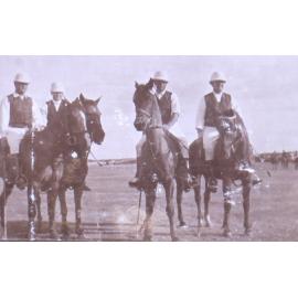 Four unidentified polo players