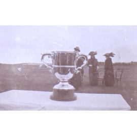 Trophy with unidentified people in the background