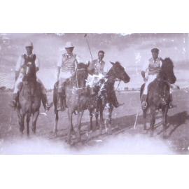 Four unidentified polo players on horseback