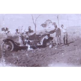 Three men and one woman with a bogged car