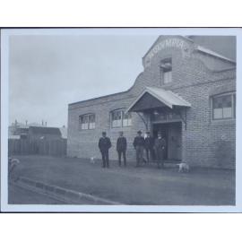Five gentlemen outside the Olympia skating rink, Armidale, NSW