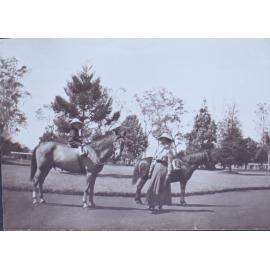 Children on horseback with unidentified woman