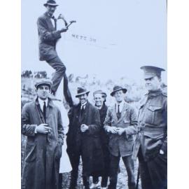 Six men (one in uniform) at Metz sign, east of Armidale, NSW