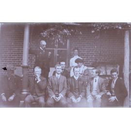 Group of eight men and two women on verandah