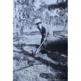 Woman with a pick in the paddock