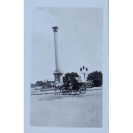 Column with a horse and buggy in the foreground