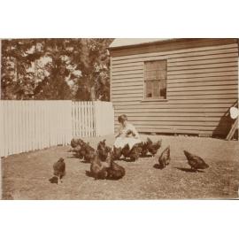 Unidentified woman with chickens