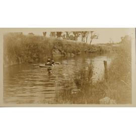Unidentified woman and two children swimming in the creek