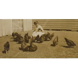 Unidentified woman with chickens