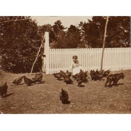 Unidentified woman with chickens