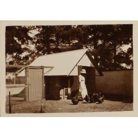 Unidentified woman with chickens