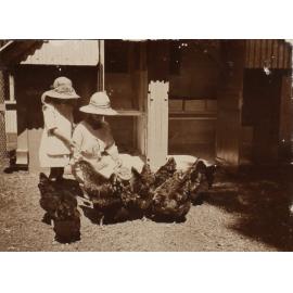 Unidentified woman and child with the chickens