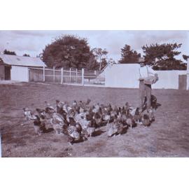 Unidentified man with chickens