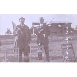 Two unidentified men holding flags