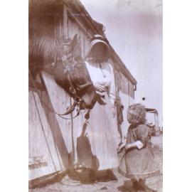 Unidentified woman and child with a horse
