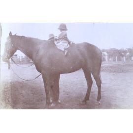 Unidentified child on a horse