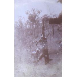 Unidentified man with a dog and dead fox