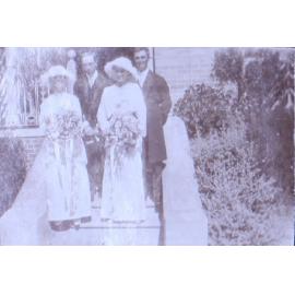 Two unidentified couples on steps