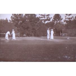 Four unidentified women on a tennis court