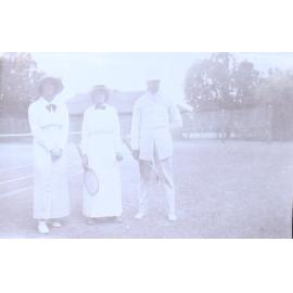 Two unidentified women and one man ready for tennis