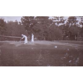 Two unidentified women on a tennis court