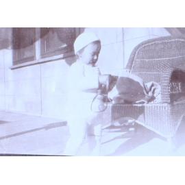 Unidentified child beside chair