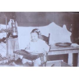Unidentified child in a high chair