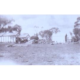 Unidentified workmen with loaded cart and cut logs in foreground