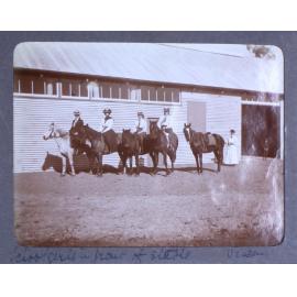 Schoolgirls in front of stable