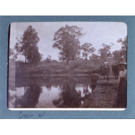 Unidentified woman beside a dam [?]