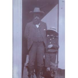 Unidentified man and boy with pet dog